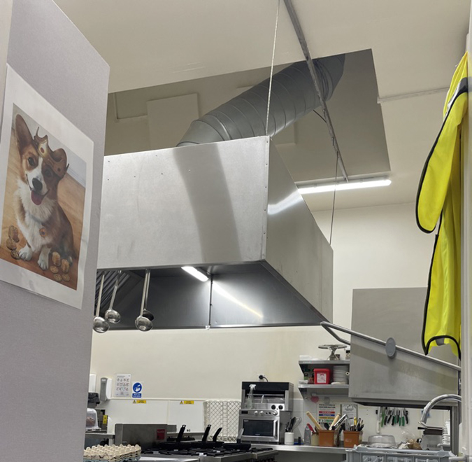 Restaurant kitchen with bright white ceiling lights